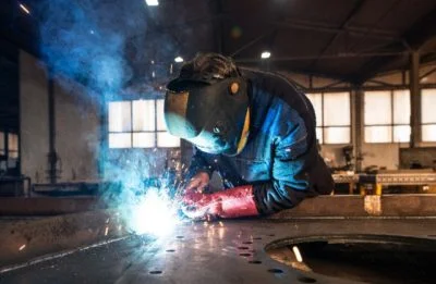 professional-industrial-welder-welding-metal-parts-metalworking-factory-400x261